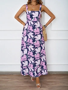Close-up detail of a summer A-line floral dress with vibrant pink and navy floral print