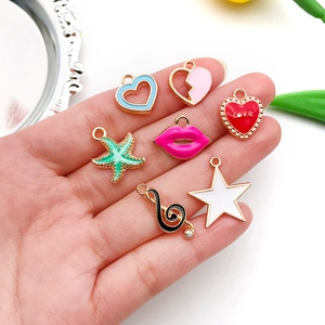 Detail of colorful drip oil alloy charms including heart and star shapes for DIY jewelry