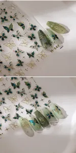 Close-up of M-547 butterfly nail stickers with gold outlines and green glitter details