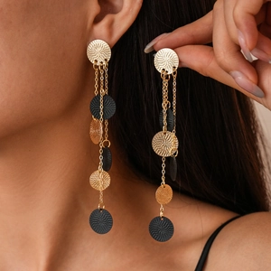 Long gold and black layered fringe earrings with spiral textured round pendants