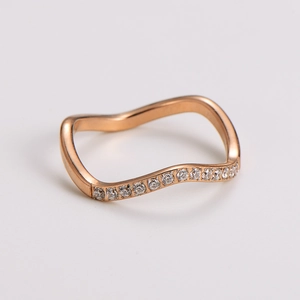 Detailed view of rose gold wavy ring band featuring half-circle micro-pave crystals