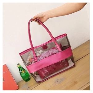 Detail view of pink PVC transparent tote bag with matching inner pouch and PU handles