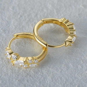 Macro detail of S925 sterling silver hoop earrings with gold plating and cubic zirconia