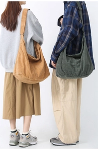 Back view of models wearing camel and dark green corduroy tote bags in large capacity style