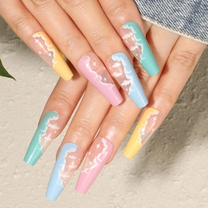 Detail of long coffin press-on nails with pastel cloud designs and star patterns
