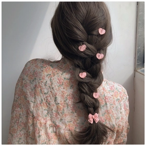 Pink heart clips and bow hair accessory set styled on a dark brown braided ponytail
