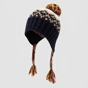 Detail of navy knit kids winter hat featuring Fair Isle patterns and braided earflaps