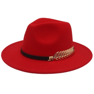 Close-up of a wide brim red wool fedora featuring a gold fishbone buckle and leather band
