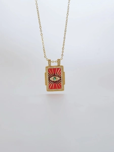 Detail of red tarot pendant necklace with evil eye and sparkling crystals for women