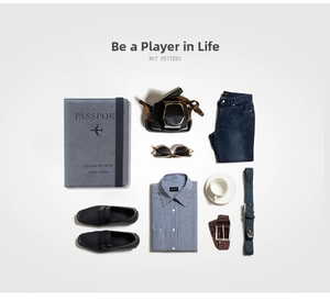 Flat lay of slim RFID travel passport holder with men accessories and vintage camera