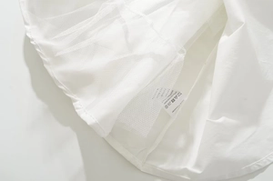 Detail view of the 100% polyester fabric label and white mesh layers on the dress