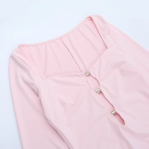 Close-up of pink long sleeve dress showing hollow square neckline and metal oval buckle