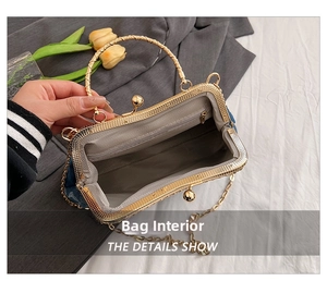 Detail view of denim bag interior featuring grey fabric lining and gold metal frame closure