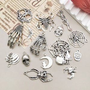Detailed collection of vintage silver gothic Halloween charms including skulls and spiders