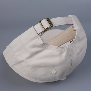 Detail of adjustable metal buckle and stitching on cotton baseball cap back