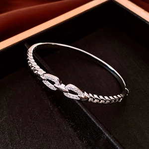 Detailed view of silver double-loop chain bracelet with sparkling pavé cubic zirconia