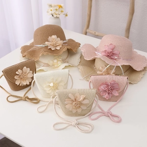 Detail of straw sun hat and matching flower bag set for girls in multiple colors