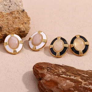 Detailed macro view of 18K gold plated oval stud earrings with black and white enamel
