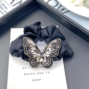 Elegant black satin hair scrunchie featuring a large crystal butterfly ornament