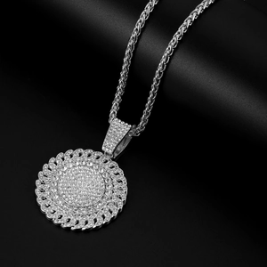 Macro detail of silver hip hop necklace with a large round pendant and pave diamonds