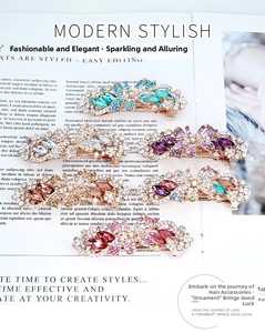 Detailed macro view of 5 flower spring hair clips with crystals and golden alloy base