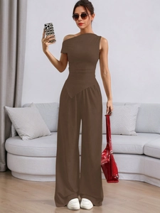 Detail of solid dark brown sleeveless one-shoulder wide-leg jumpsuit with high-waist cut