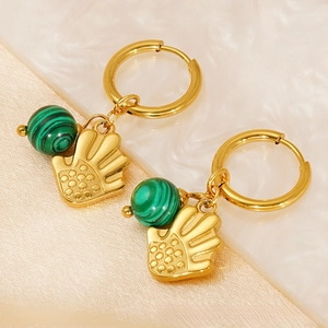 Detail of 18k gold earrings with green malachite beads and palm hand pendants