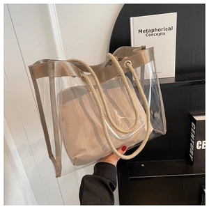 Detail of transparent PVC tote bag with khaki fabric trim and sturdy hemp rope handles