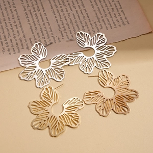 Statement hollow flower earrings in gold and silver finish with bohemian metal design