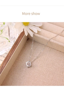 Detailed view of square hollow cubic pendant with zircon on a silver chain necklace