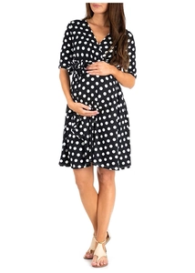 Front view of black polka dot maternity dress featuring a V-neck and high waist line