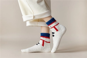 Close-up of white plush Christmas socks featuring a snowman pattern and blue trim