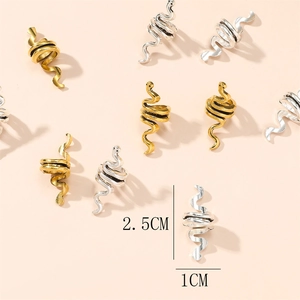 Detailed view of 2.5cm gold and silver snake-shaped metal braid rings and hair cuffs