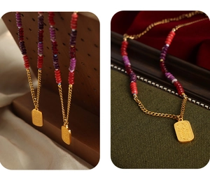 Close-up of golden rectangular charm with Chinese characters on a colorful beaded necklace