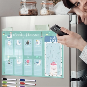 Close-up of magnetic acrylic weekly planner with alpaca pattern on a refrigerator