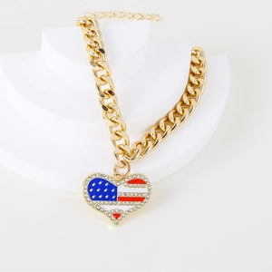Detailed macro view of the gold pet chain necklace with a rhinestone USA flag heart pendant