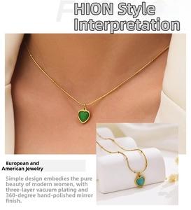 Detail of green malachite heart pendant on a gold beaded chain with polished finish
