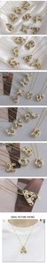 Macro detail of gold plated leopard print letter pendant necklace with pavé zircons and bead chain