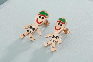 Macro shot of rose gold cartoon stud earrings with colorful enamel paint details
