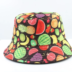 Close-up of reversible bucket hat featuring vibrant all-over colorful fruit pattern prints