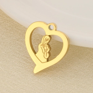 Detail of a golden heart-shaped pendant featuring a mother and child embrace design