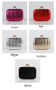 Detail of evening clutch bags with metallic pleated texture and golden ball clasps