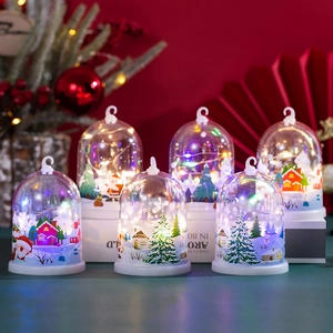 Close-up of LED Christmas lanterns with Santa and snow scenes in warm light settings