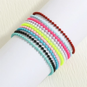 Colorful Bohemian beaded bracelets in multiple vibrant colors stacked on a white display stand