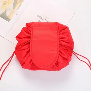 Detail view of red drawstring makeup bag with waterproof fabric and secure flap closure