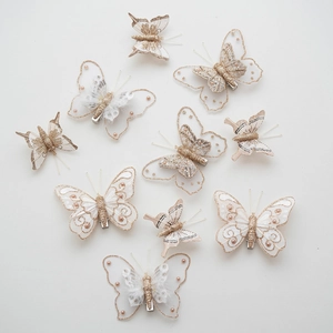 Set of decorative white and gold feather butterfly clips with mesh and pearls