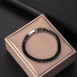 Silver tennis bracelet featuring rectangular black zircon stones on a luxury box