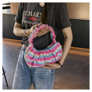 Detail of colorful rainbow pleated shoulder bag with vibrant gradient texture and ruffles