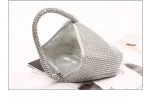 Detail view of silver rhinestone evening bag interior with satin lining and inner pocket