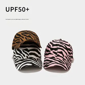Zebra print baseball caps in pink, white, and brown colors with UPF50+ sun protection